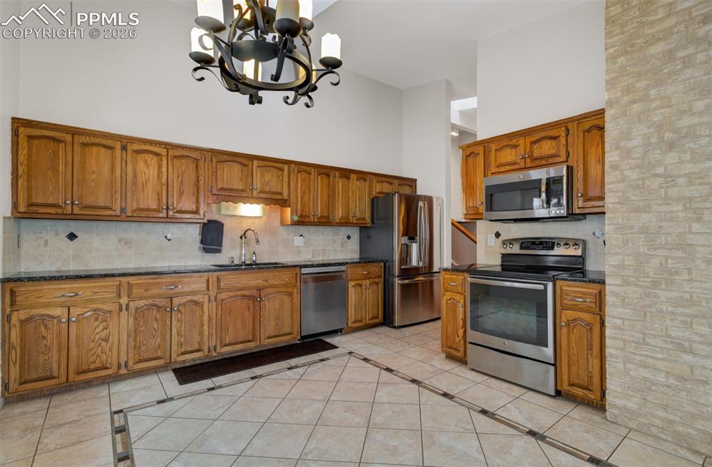 5865 Waterfall Loop Manitou Springs, CO 80829 - Photo 3 of 45 Kitchen with stainless steel appliances, granite counters and custom tile flooring!