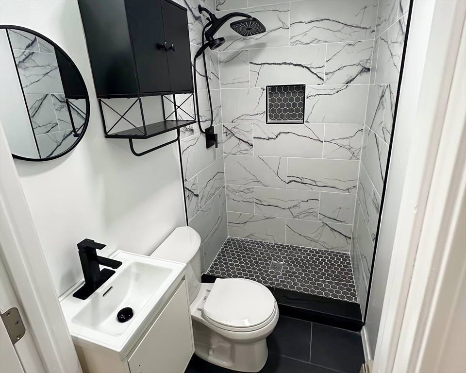 4 Bartlett Street, Unit 2 Taunton, MA 02780 - Photo 11 of 14 a bathroom with a toilet and a sink