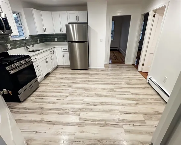 a kitchen with a refrigerator a stove top oven a sink and dishwasher