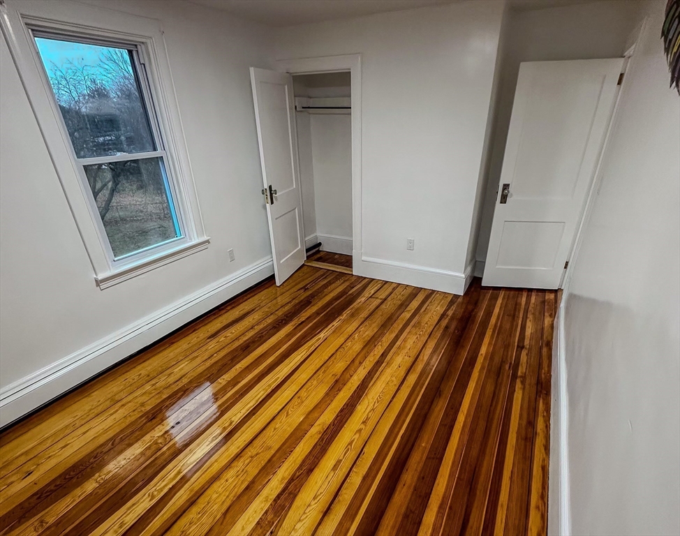 4 Bartlett Street, Unit 2 Taunton, MA 02780 - Photo 5 of 14 a bedroom with wooden floor and a window