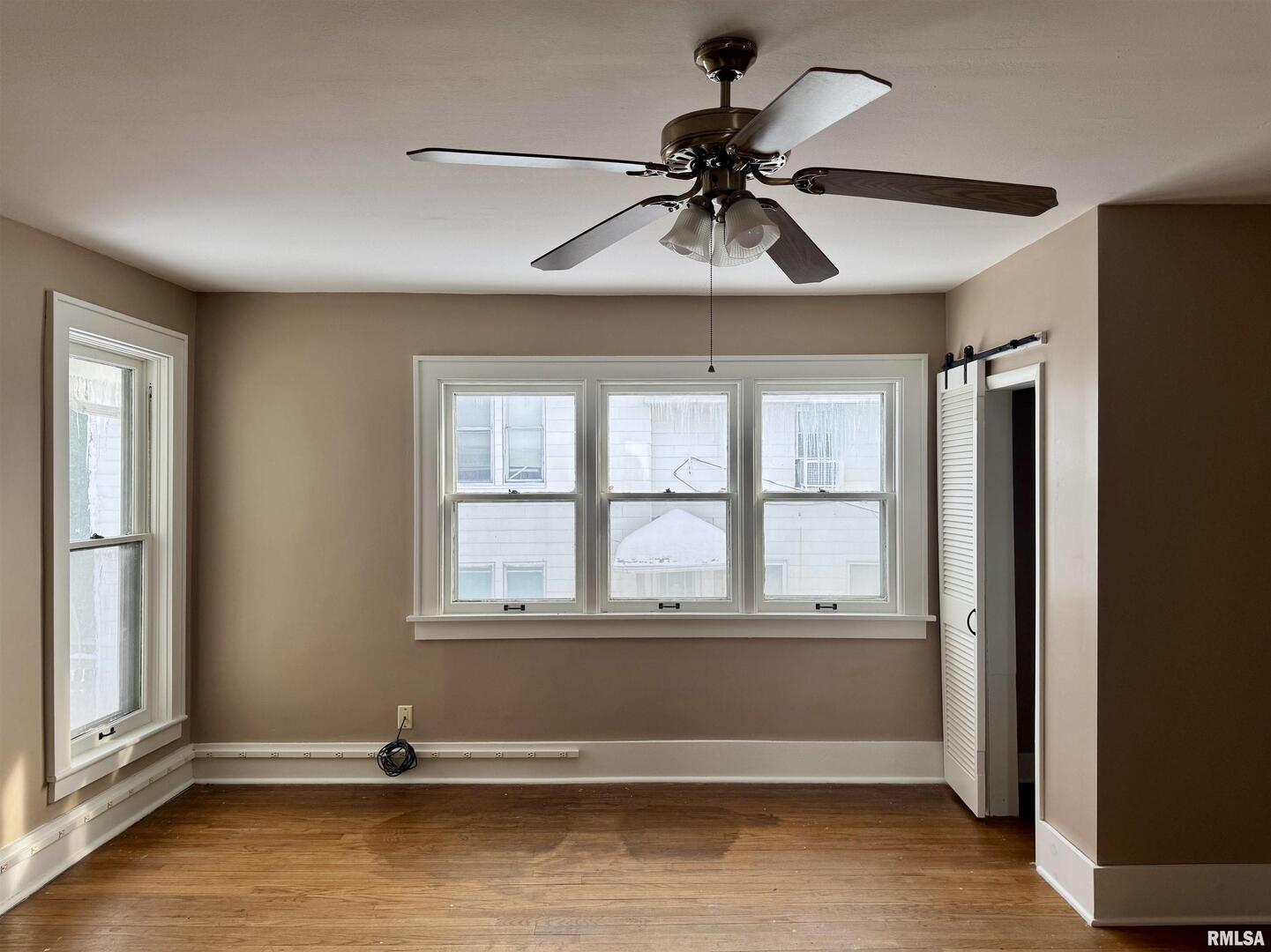 609 5th Avenue South Clinton, IA 52732 - Photo 16 of 25 a view of room with a ceiling fan and window