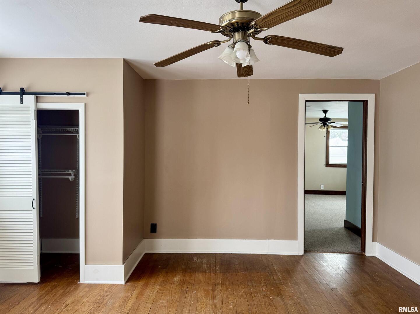 609 5th Avenue South Clinton, IA 52732 - Photo 17 of 25 wooden floor in an empty room with a window