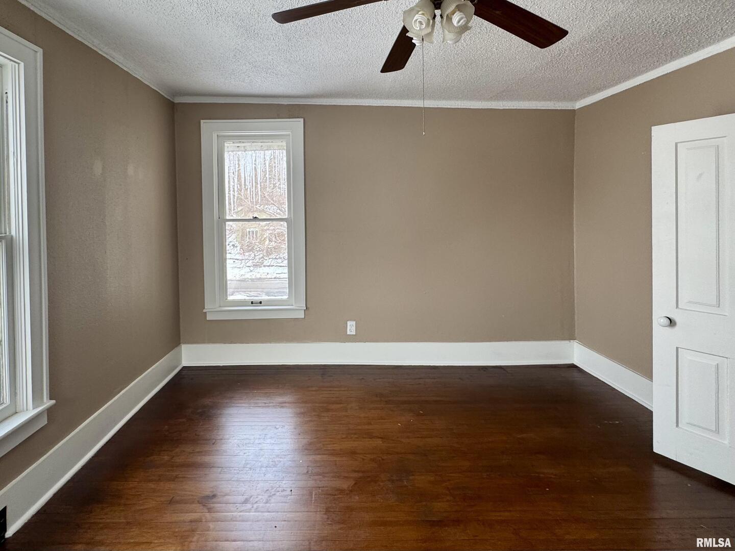 609 5th Avenue South Clinton, IA 52732 - Photo 20 of 25 an empty room with wooden floor chandelier fan and windows