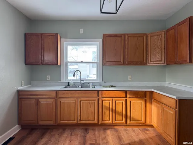 a kitchen with wooden cabinets a sink and dishwasher