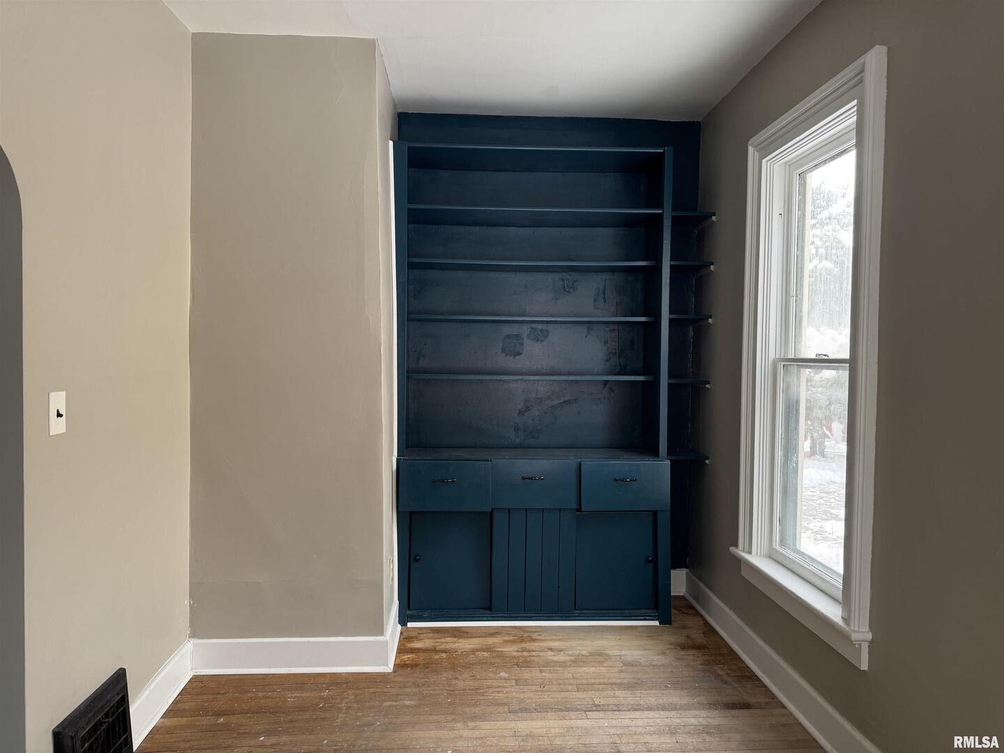 609 5th Avenue South Clinton, IA 52732 - Photo 9 of 25 a view of an empty room with wooden floor and a window