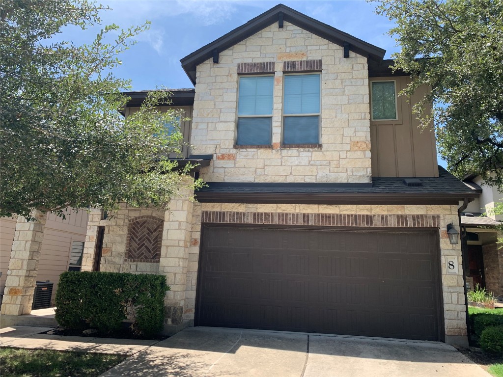a front view of a house with plants