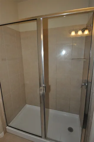 a bathroom with a shower and a bath tub