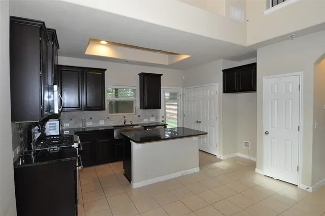 a kitchen with a sink and refrigerator