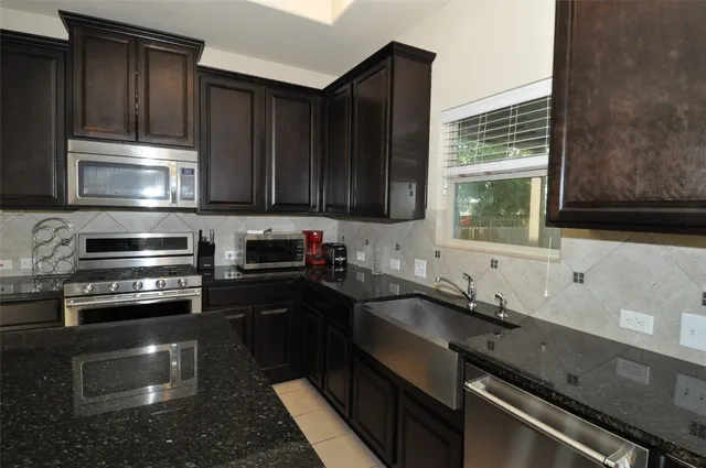 a kitchen with a sink stove and microwave