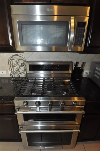 a stove top oven sitting inside of a kitchen