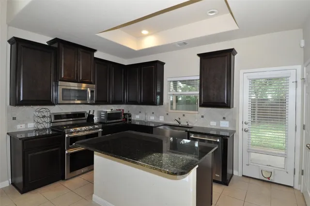 a kitchen with a sink stove and microwave