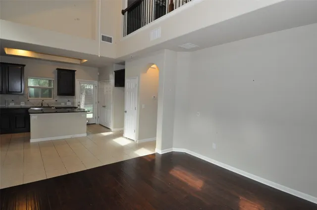 a view of a kitchen with wooden floor and stainless steel appliances