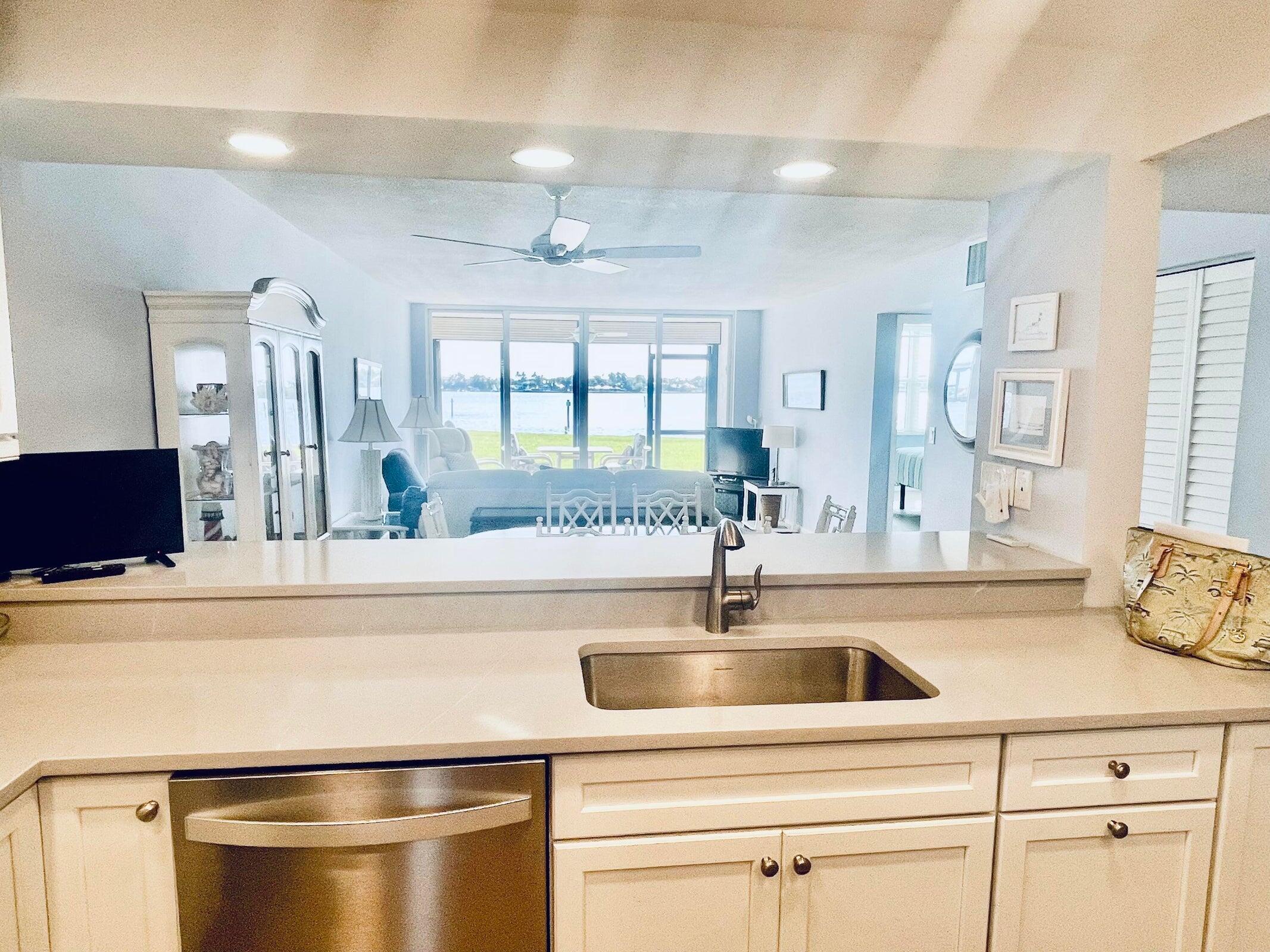 1950 Southwest Palm City Road, Unit 13104 Stuart, FL 34994 - Photo 2 of 12 a kitchen with a sink and cabinets