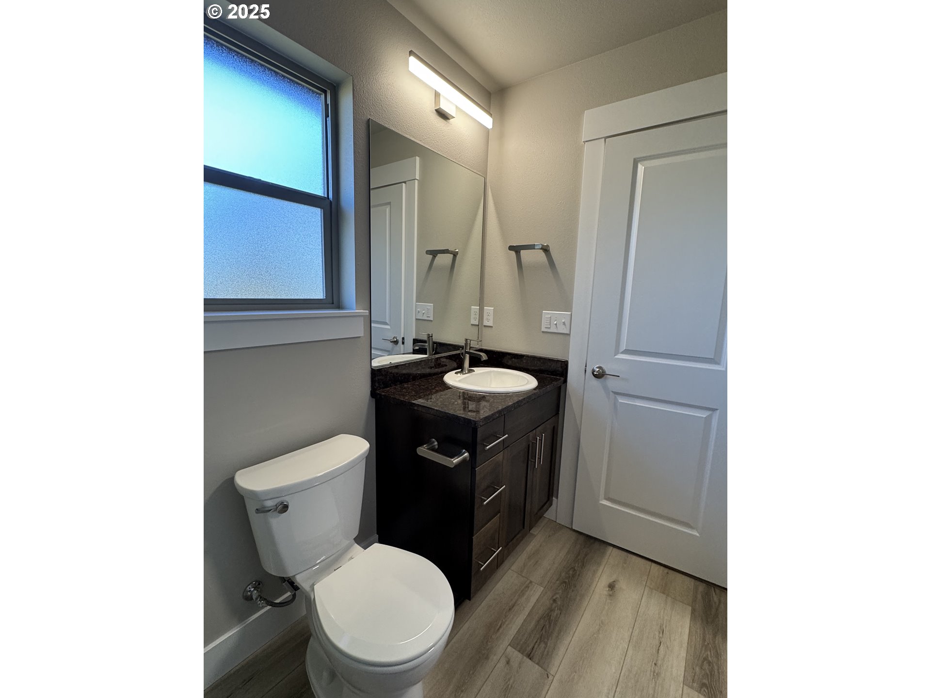 119 Lebleu Lane Winston, OR 97496 - Photo 24 of 30 a bathroom with a toilet sink vanity and mirror