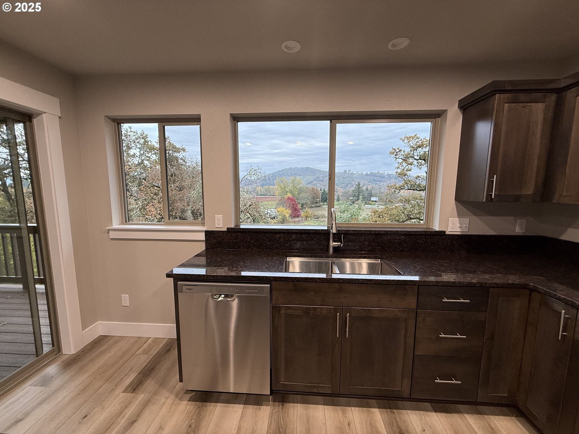 119 Lebleu Lane Winston, OR 97496 - Photo 30 of 30 a kitchen with kitchen island a sink wooden floor and a large window