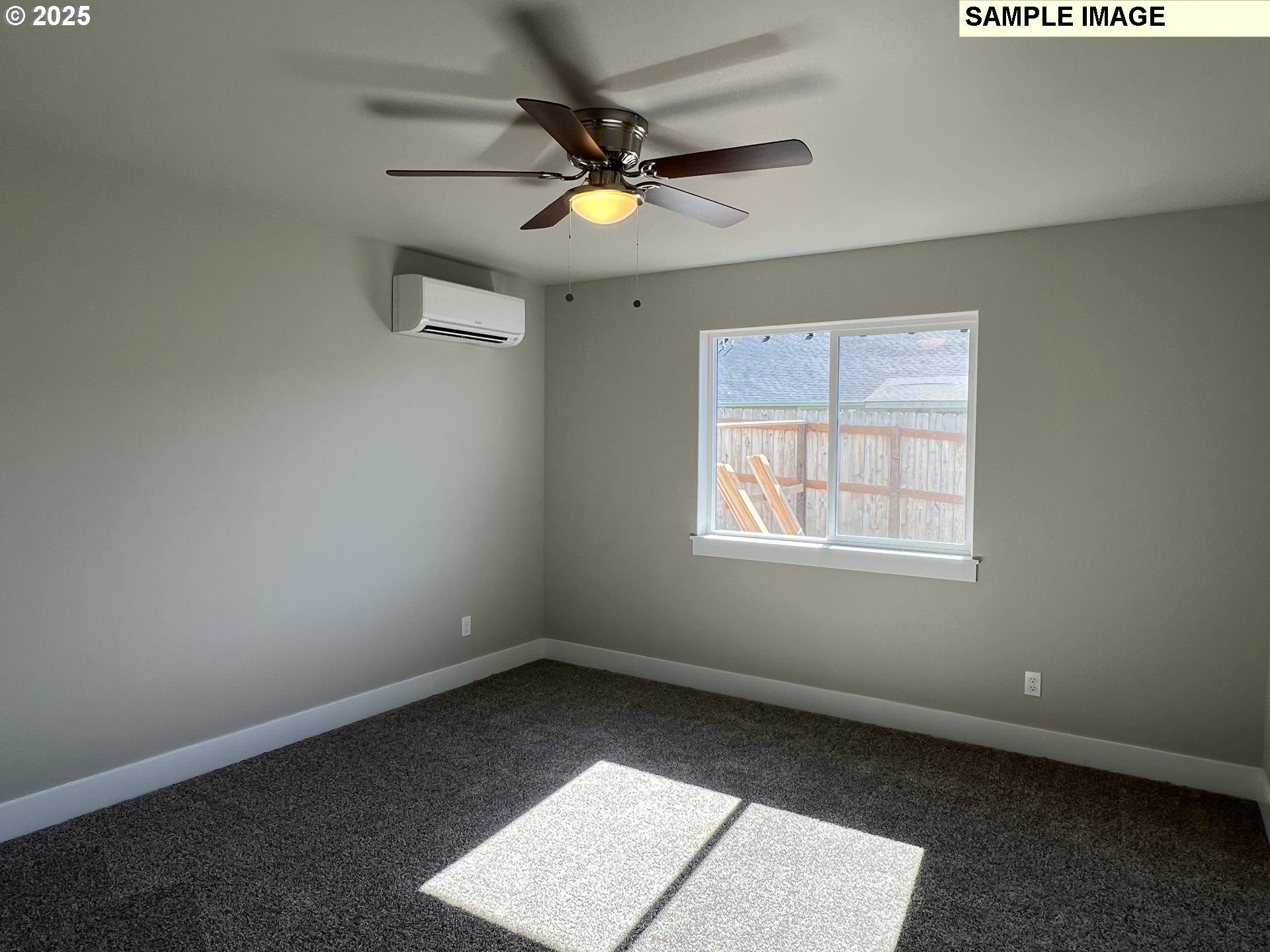 119 Lebleu Lane Winston, OR 97496 - Photo 8 of 30 an empty room with a ceiling fan and window