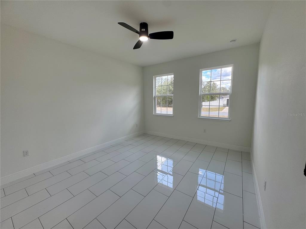12970 Southwest 43rd Ave Road Ocala, FL 34473 - Photo 16 of 44 wooden floor in an empty room with a window