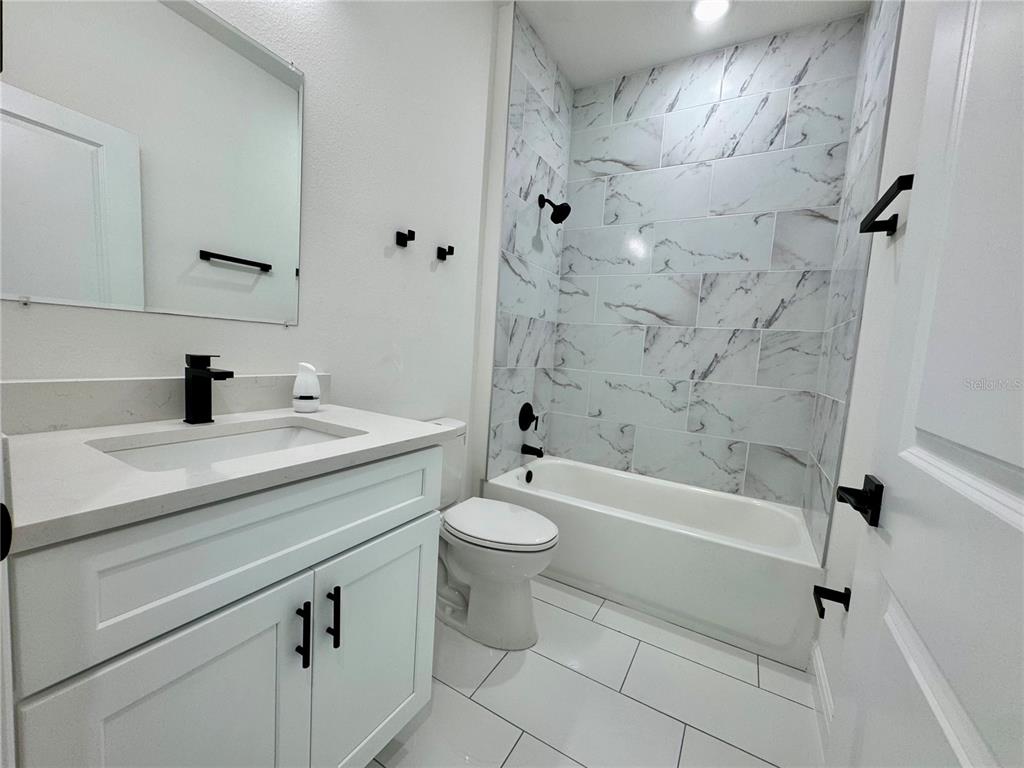 12970 Southwest 43rd Ave Road Ocala, FL 34473 - Photo 30 of 44 a bathroom with a sink a toilet and a bathtub