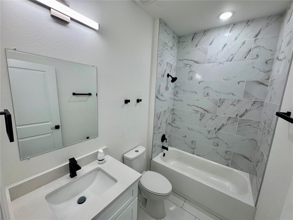 12970 Southwest 43rd Ave Road Ocala, FL 34473 - Photo 31 of 44 a bathroom with a sink a toilet and shower