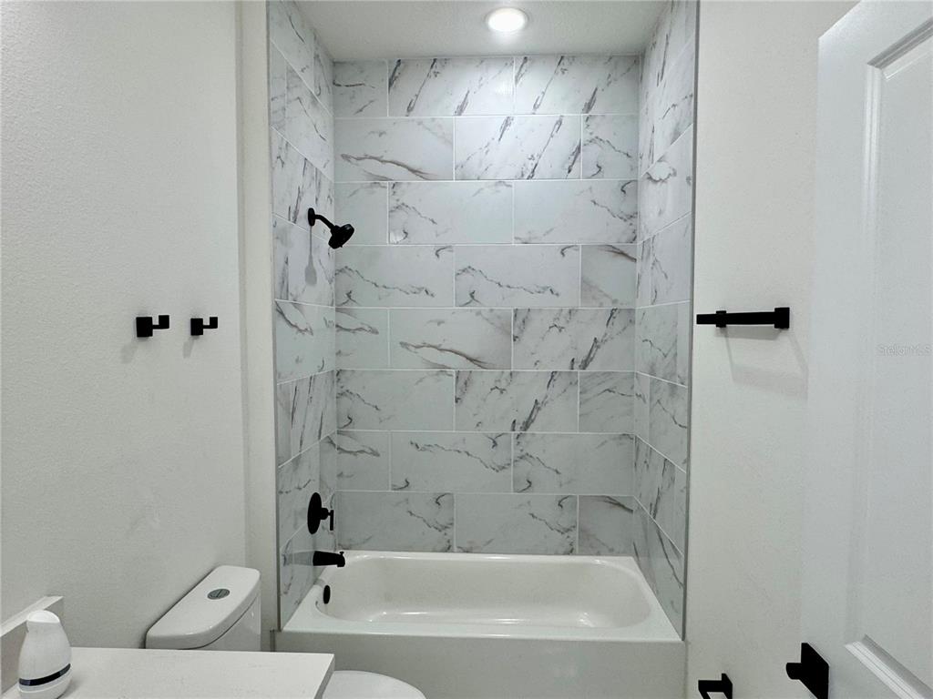 12970 Southwest 43rd Ave Road Ocala, FL 34473 - Photo 32 of 44 a bathroom with a bathtub and a shower