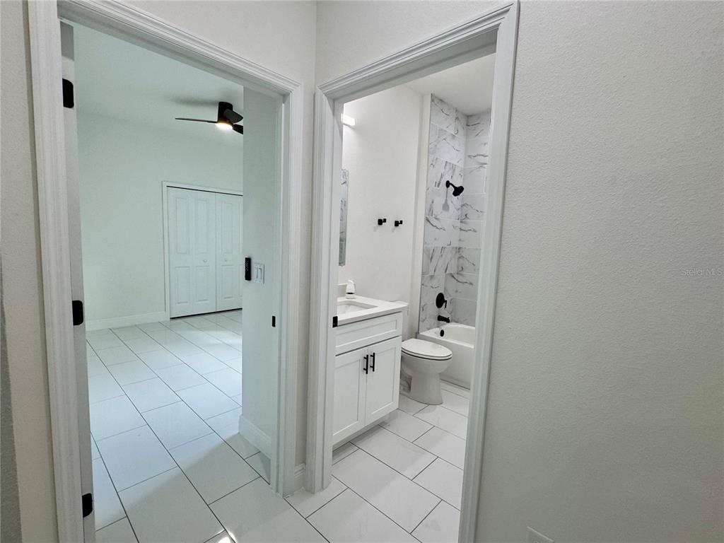 12970 Southwest 43rd Ave Road Ocala, FL 34473 - Photo 36 of 44 a bathroom with a granite countertop toilet a sink and a mirror