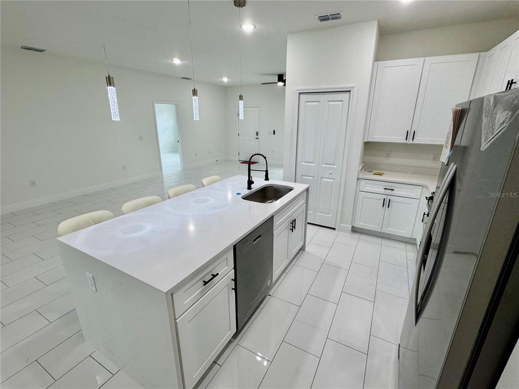 12970 Southwest 43rd Ave Road Ocala, FL 34473 - Photo 38 of 44 a kitchen with a sink stove and refrigerator