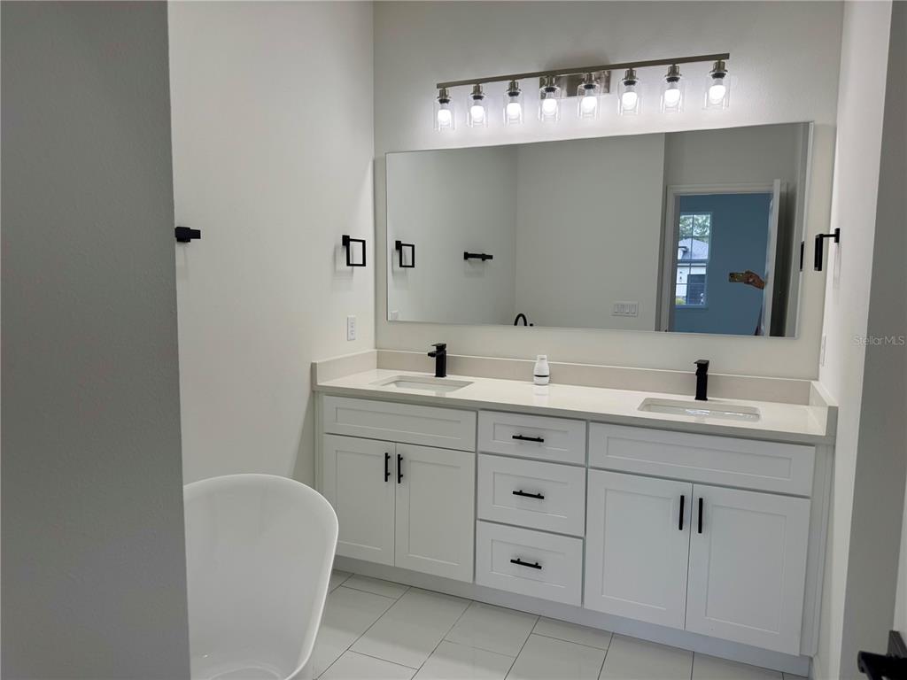 12970 Southwest 43rd Ave Road Ocala, FL 34473 - Photo 7 of 44 a bathroom with a double vanity sink and a mirror