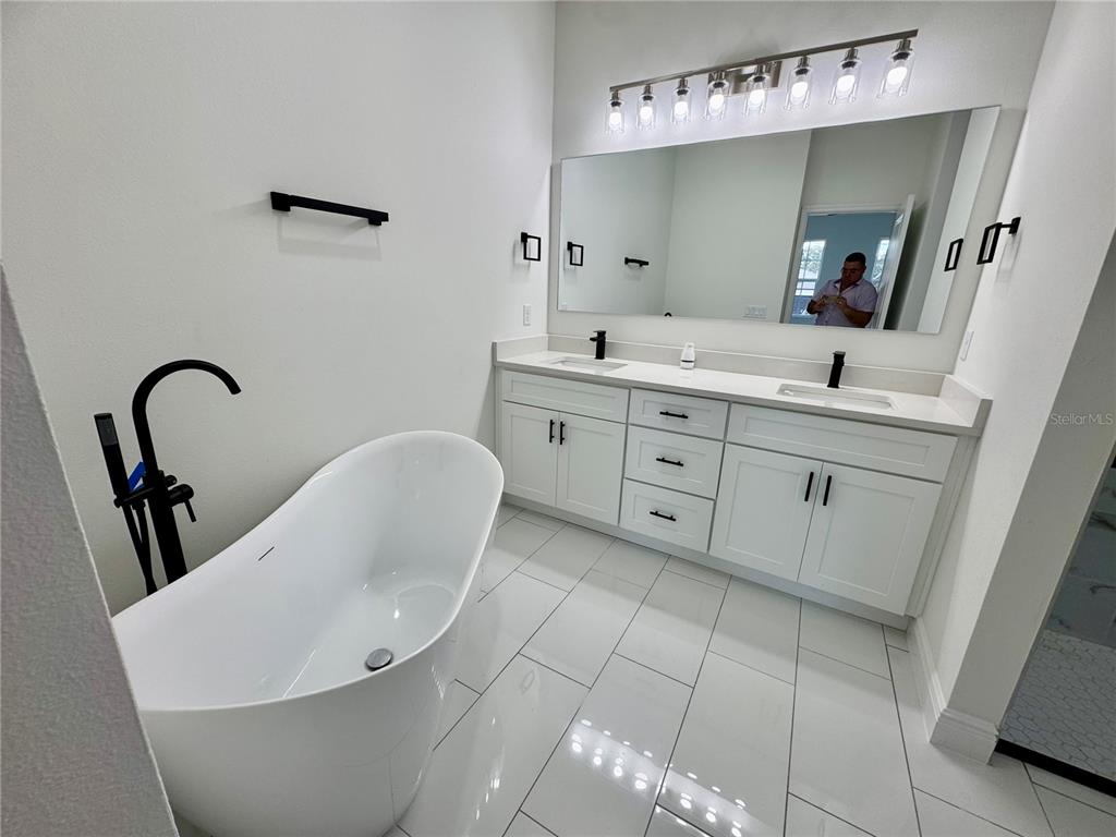 12970 Southwest 43rd Ave Road Ocala, FL 34473 - Photo 9 of 44 a bathroom with a white tub sink vanity and mirror