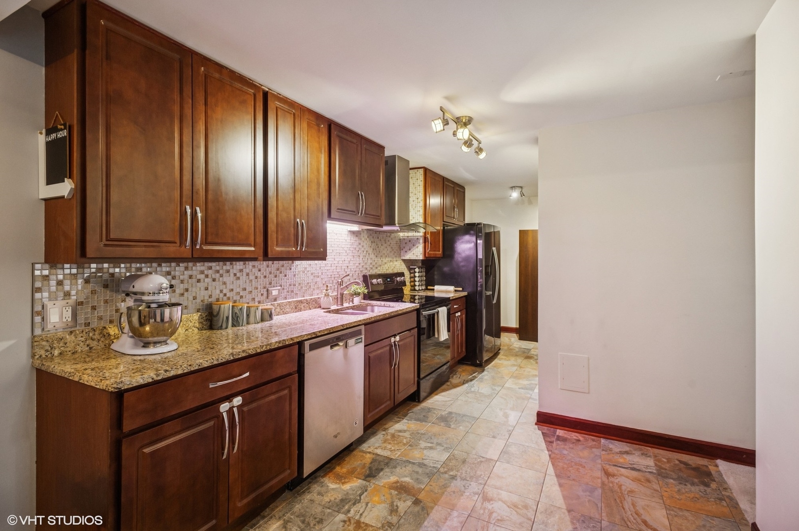 205 Ridge Road, Unit 204 Wilmette, IL 60091 - Photo 7 of 16 a kitchen with stainless steel appliances granite countertop a sink stove and refrigerator
