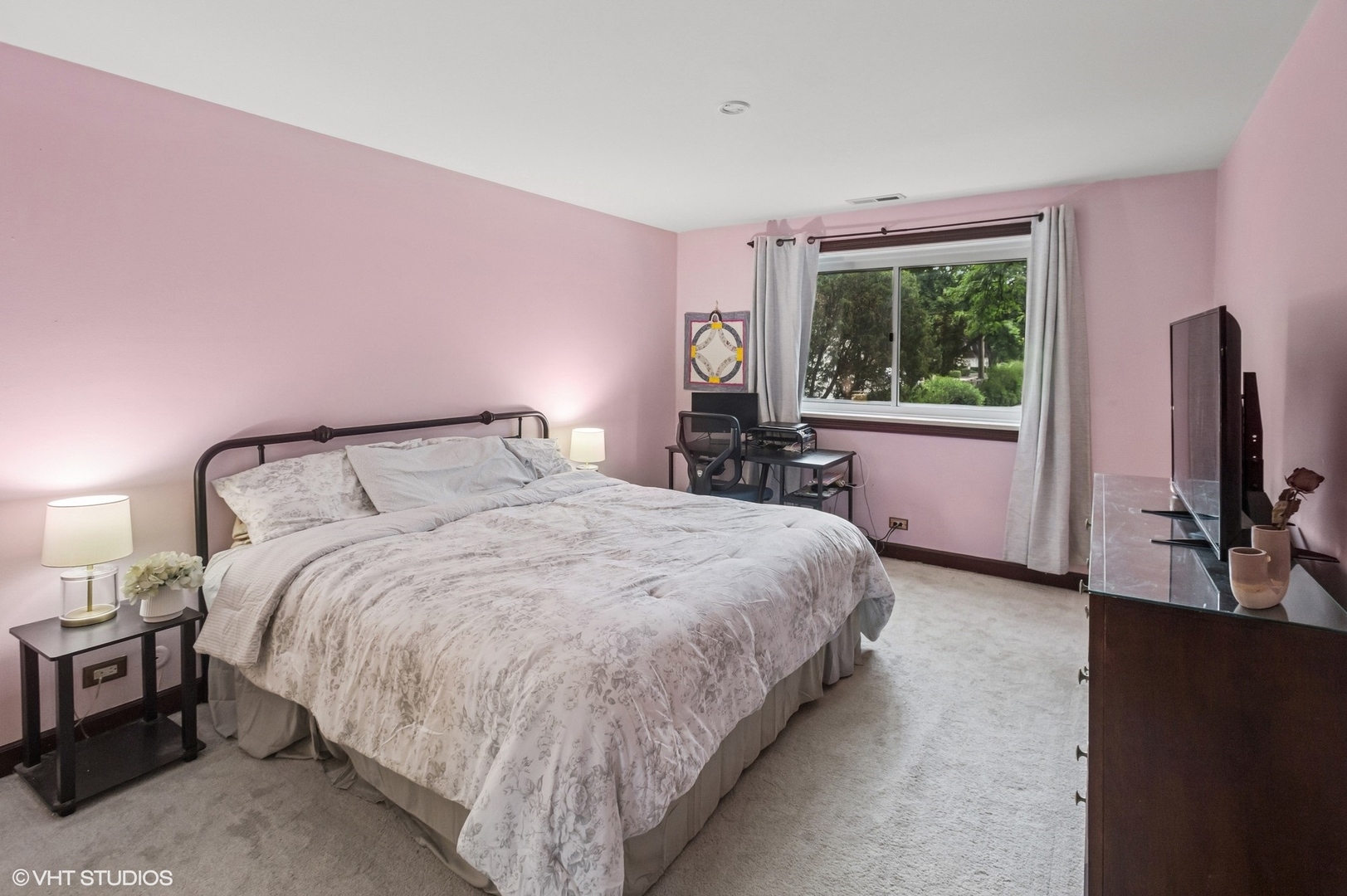 205 Ridge Road, Unit 204 Wilmette, IL 60091 - Photo 8 of 16 a large bed sitting in a bedroom next to a window with tv