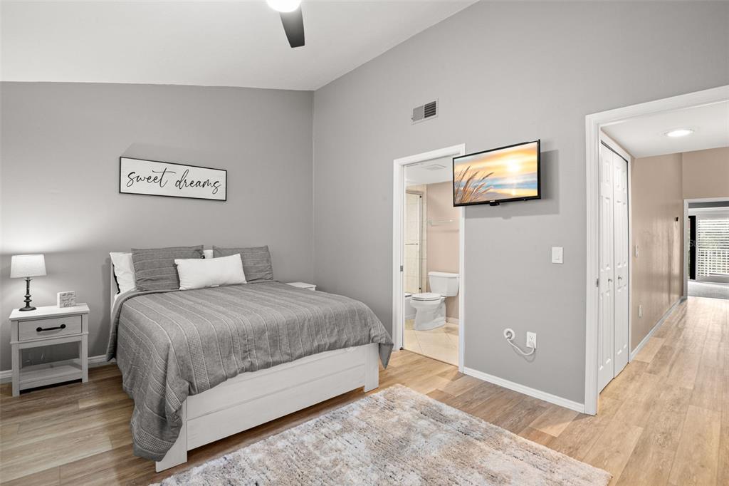 529 Sandy Hook Road Treasure Island, FL 33706 - Photo 35 of 55 a spacious bedroom with a bed and a tv