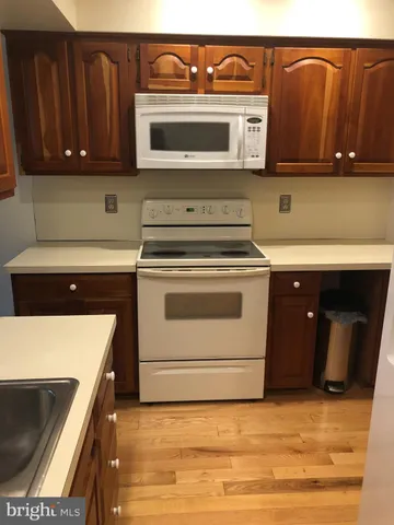 a kitchen with stainless steel appliances granite countertop a stove and a microwave