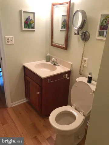 a white toilet sitting next to a shower