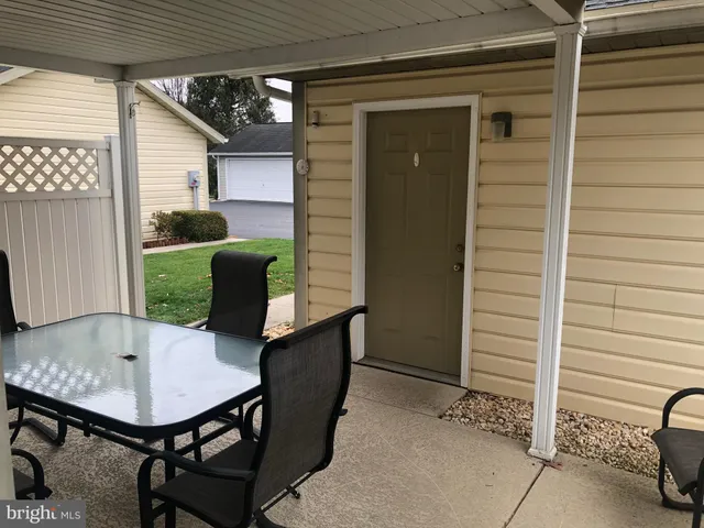 a view of a porch with furniture and yard