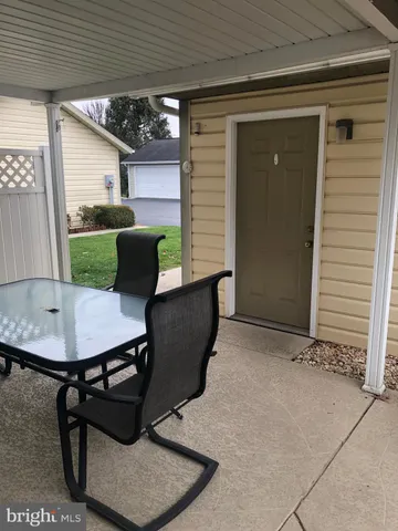 a view of a patio in the backyard