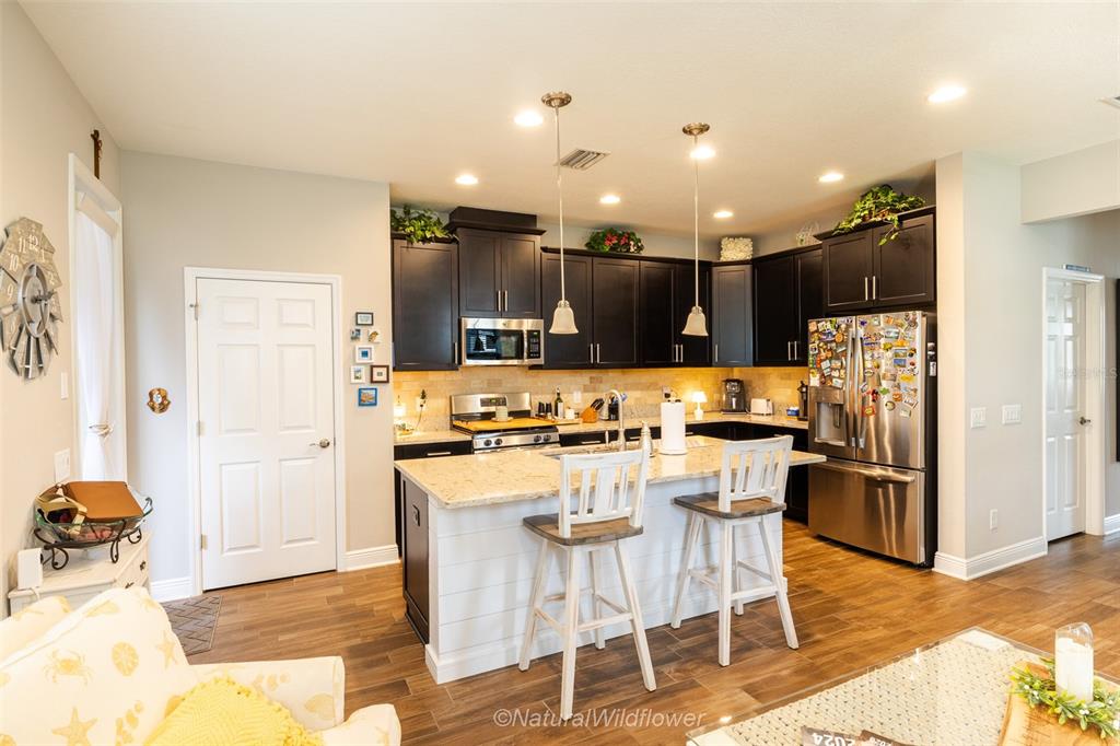 12556 Rangeland Boulevard Odessa, FL 33556 - Photo 11 of 29 a large kitchen with a table and chairs