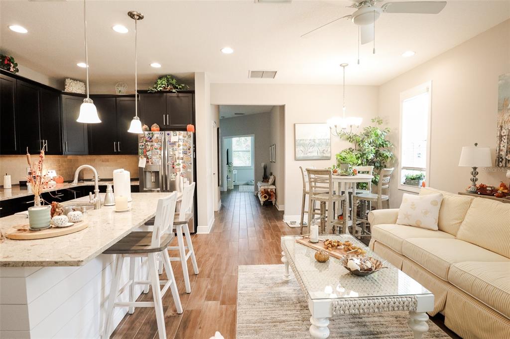 12556 Rangeland Boulevard Odessa, FL 33556 - Photo 11 of 27 a living room with furniture kitchen view and a large window