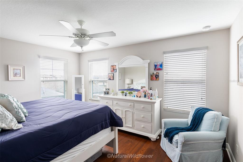 12556 Rangeland Boulevard Odessa, FL 33556 - Photo 18 of 29 a bedroom with a bed and a couch