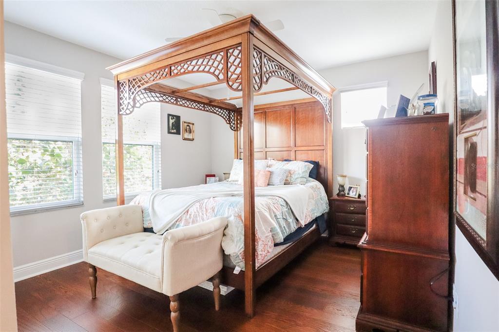 12556 Rangeland Boulevard Odessa, FL 33556 - Photo 19 of 27 a bedroom with a bed and wooden floor