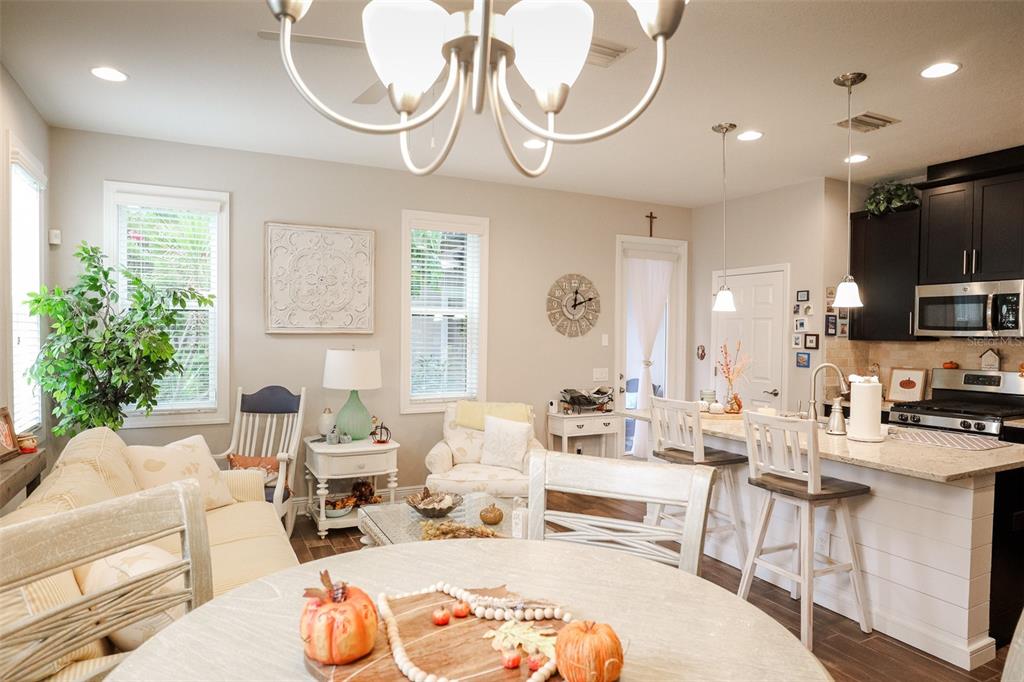 12556 Rangeland Boulevard Odessa, FL 33556 - Photo 2 of 27 a living room with furniture a chandelier and a large window