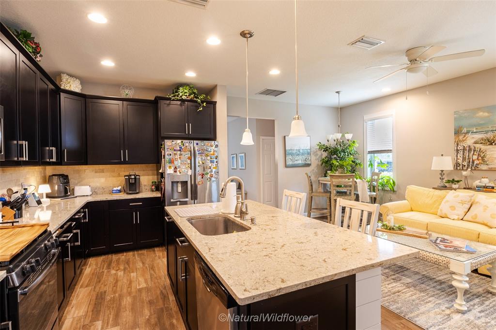 12556 Rangeland Boulevard Odessa, FL 33556 - Photo 2 of 29 a kitchen with a stove a sink and a refrigerator