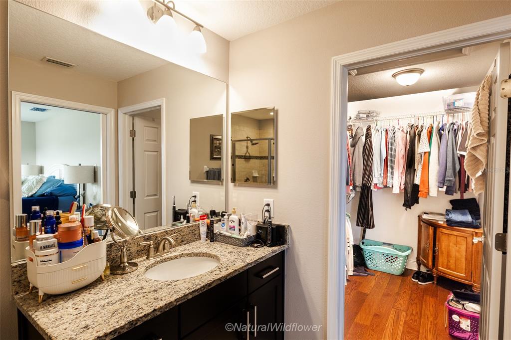 12556 Rangeland Boulevard Odessa, FL 33556 - Photo 21 of 29 a bathroom with a granite countertop sink and a mirror