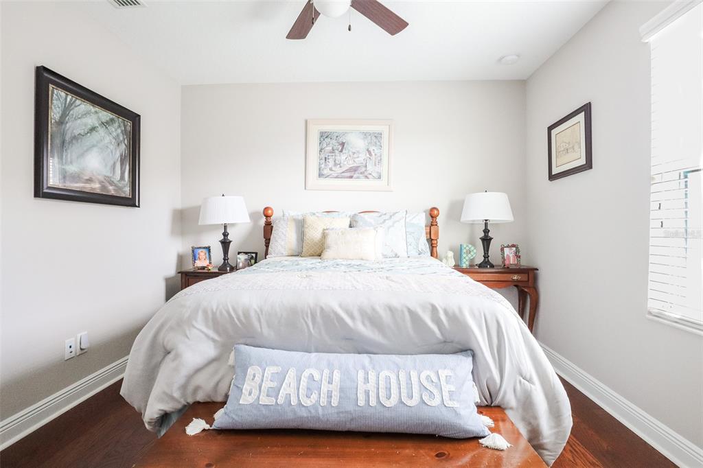 12556 Rangeland Boulevard Odessa, FL 33556 - Photo 22 of 27 a bedroom with a bed and a painting on the wall