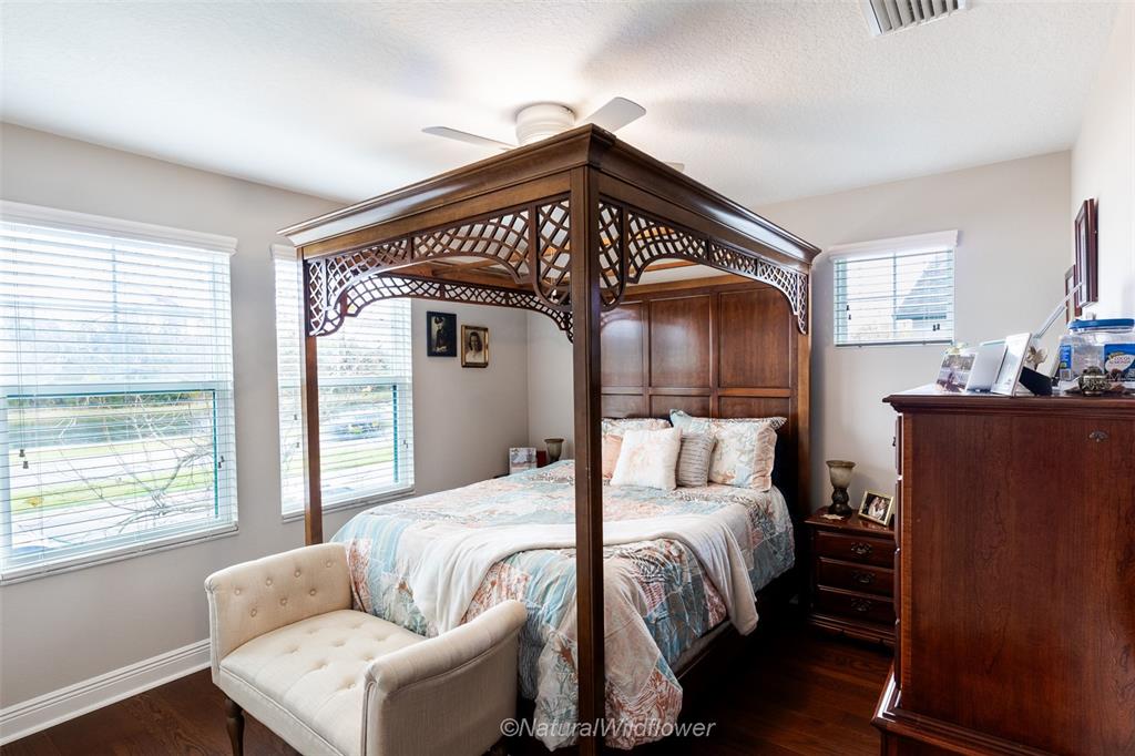 12556 Rangeland Boulevard Odessa, FL 33556 - Photo 22 of 29 a bedroom with a bed and wooden floor