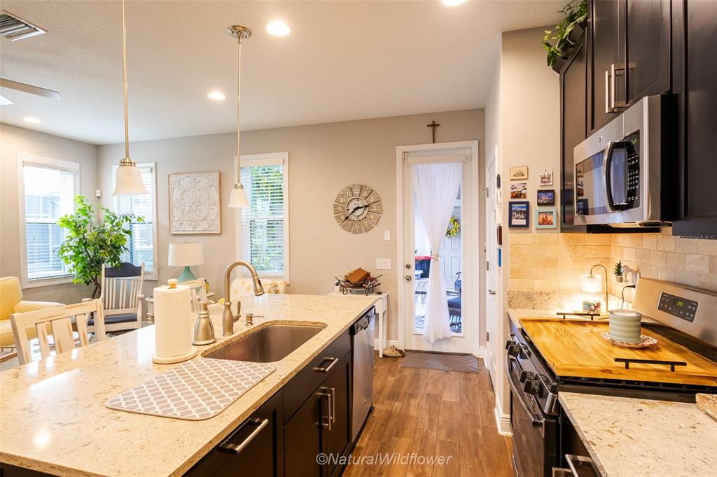 12556 Rangeland Boulevard Odessa, FL 33556 - Photo 8 of 29 a kitchen with stainless steel appliances a sink stove and refrigerator
