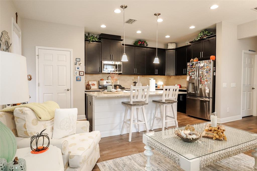 12556 Rangeland Boulevard Odessa, FL 33556 - Photo 10 of 27 a kitchen with stainless steel appliances kitchen island granite countertop a sink and cabinets
