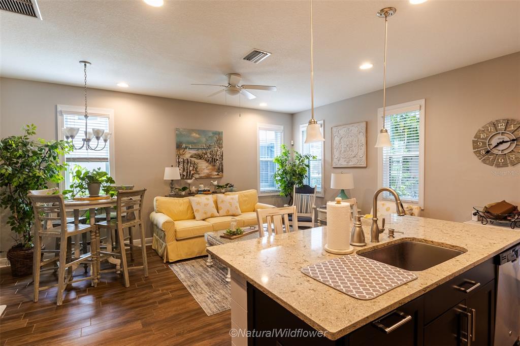 12556 Rangeland Boulevard Odessa, FL 33556 - Photo 10 of 29 a kitchen with a table chairs sink and wooden floor