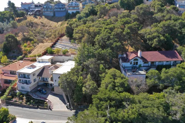 an aerial view of multiple houses with yard