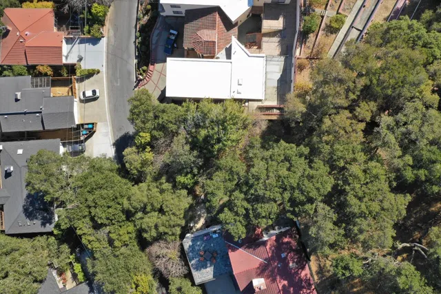 an aerial view of a house with a yard and garden