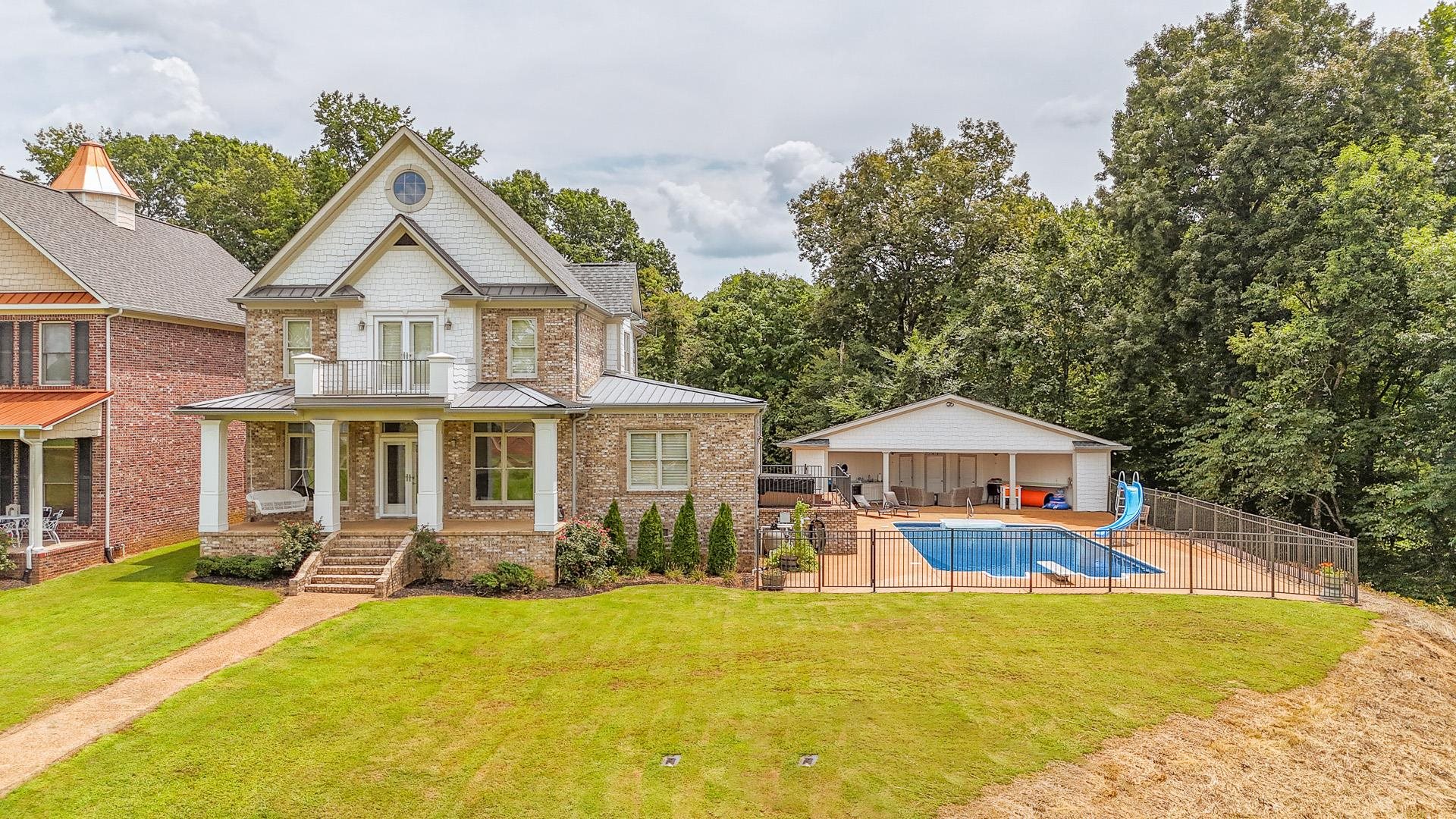 a front view of house with yard outdoor seating and barbeque oven